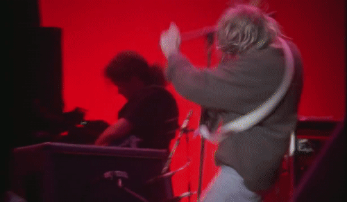 gif of kurt cobain getting tangled in cords and swinging his guitar around like a windmill